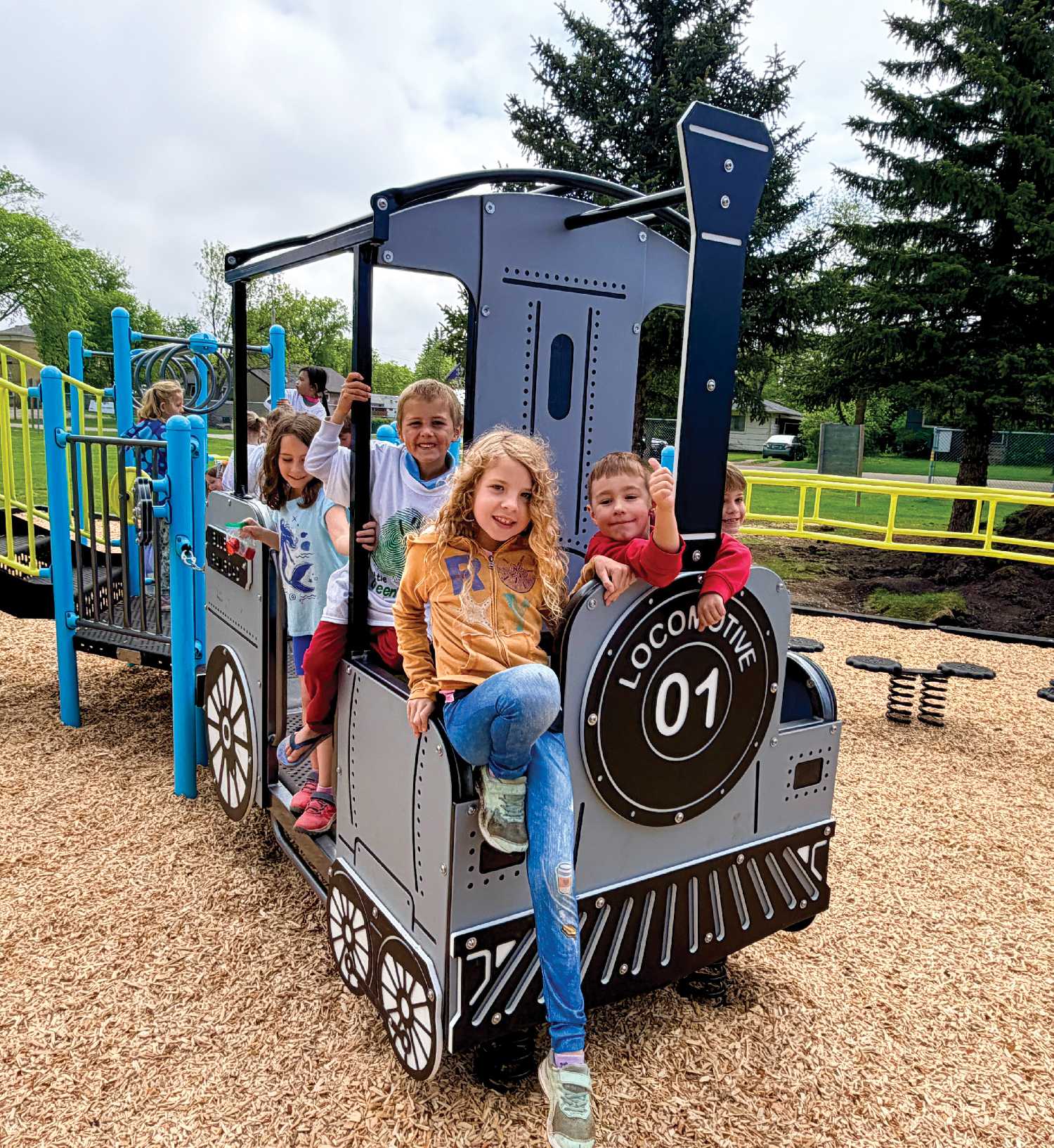 Students at MacLeod School check out the new playground equipment.