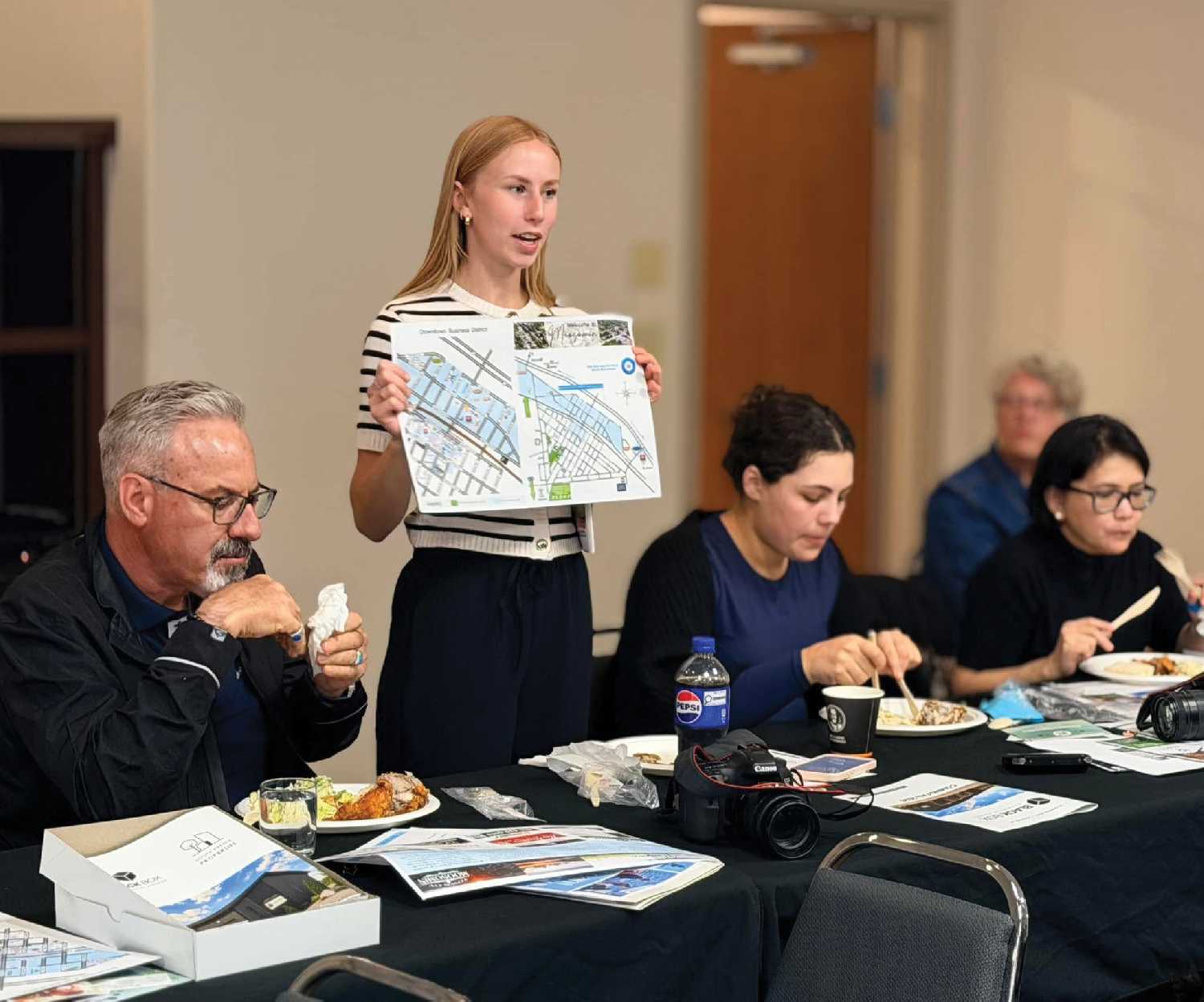 Ashley Bochek tells Chamber of Commerce members about the Chamber's map project at the Chamber meeting Monday.